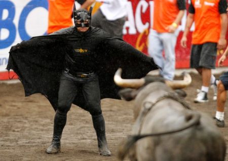 A man wearing a Batman costume gestures towards a bull in an improvised bullring during the annual bullfight festival in Zapote, near San Jose December 30, 2010. More than 350 bullfighters participated in the traditional end of year bullfight. REUTERS/Juan Carlos Ulate (COSTA RICA - Tags: SOCIETY ANIMALS TRAVEL IMAGES OF THE DAY)