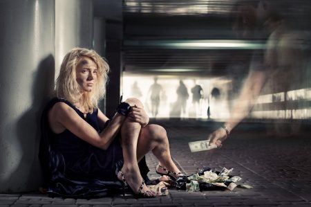 luxury beggar girl is sitting on the floor in subway